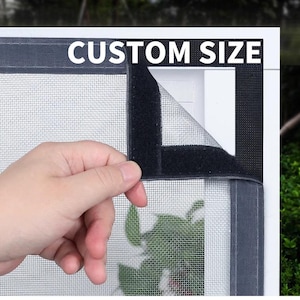 May include: A black mesh screen with a velcro border, labelled "CUSTOM SIZE" in white text. The screen is partially peeled back, revealing the mesh and a glimpse of greenery. The screen is designed to fit a window or door.