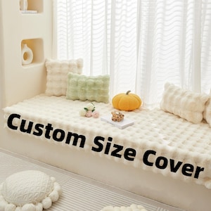 May include: A cream-colored custom size cover with a textured surface, featuring decorative pillows in cream and green. A small orange pumpkin and a book are also on the cover. The text "Custom Size Cover" is displayed on the cover.