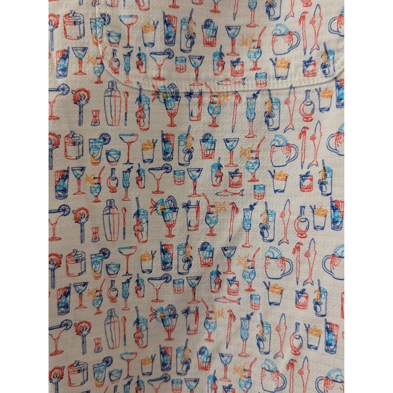 May include: A white fabric featuring a repeating pattern of various cocktail glasses, shakers, and stirrers in shades of blue, orange, and red. The design includes diverse glassware shapes such as coupes, highballs, and mugs, all rendered in line art.