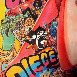 May include: A vibrant, colorful illustration featuring cartoon characters and tropical elements. The artwork includes bananas, a palm tree, and the word "PIECE" in bold, multi-colored letters. The style is reminiscent of comic book art.