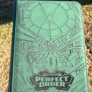 May include: A light green trading card binder featuring a dark green line art illustration of a creature with multiple limbs beneath a large circular emblem. The text MEGA EVOLUTION PERFECT ORDER is printed in bold dark green letters at the bottom.