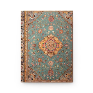 May include: A hardback journal with a teal, floral design resembling an antique rug. The pattern includes a central medallion in yellow, pink, and orange, surrounded by detailed floral motifs. The journal's spine is bordered with a dark floral pattern.