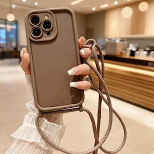 Axelskal med snodd för iPhone 11–16 Pro Max, stötsäkert mjukt fodral