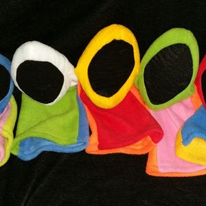 May include: Five colorful finger puppets with black felt faces. The puppets are made of soft, plush fabric and are in the colors pink, green, red, orange, and blue.