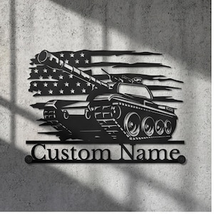 May include: A black metal wall sign featuring a silhouette of a battle tank positioned in front of a distressed American flag design. Below the tank, a horizontal bar includes the text Custom Name in a bold, serif font with circular mounts.