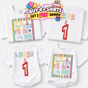 May include: Four white garments including two short-sleeve t-shirts and two baby bodysuits. The designs feature colorful text reading IT'S FUN TO BE ONE, Logan's first birthday, and the number 1 with a candle graphic. A promotional banner is visible.