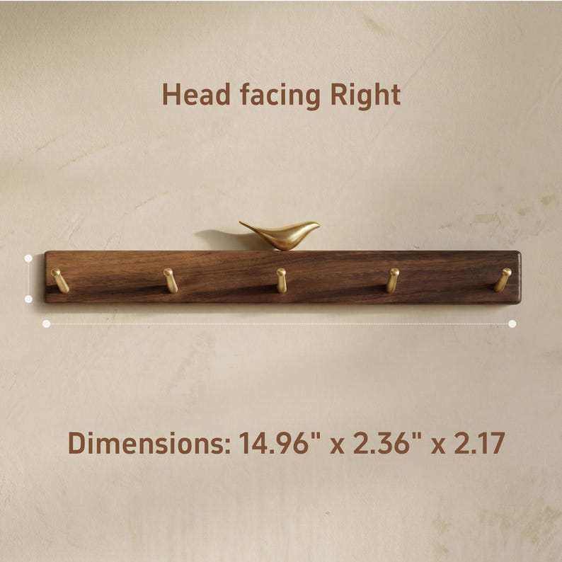 May include: A wooden wall-mounted coat rack with five brass hooks and a decorative gold-colored bird. The rack measures 14.96 inches long, 2.36 inches wide, and 2.17 inches high. The text "Head facing Right" is above the rack.
