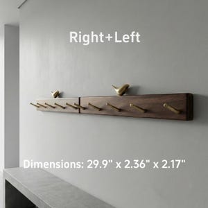 May include: A dark brown wooden wall-mounted coat rack with brass hooks and decorative bird figurines. The rack is rectangular and features multiple hooks for hanging items. The text "Right+Left" is above the rack.