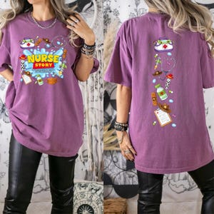 May include: A purple short-sleeve t-shirt featuring a graphic print. The front displays the text NURSE STORY TO INFINITY AND BEYOND FOR OUR PATIENTS with medical and space-themed icons. The back shows a vertical arrangement of the same icons.