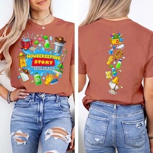 May include: A terracotta-colored t-shirt featuring a graphic print of cleaning supplies and the text HOUSEKEEPING STORY TO INFINITY AND BEYOND FOR OUR PATIENTS on the front, and a vertical arrangement of cleaning icons on the back.