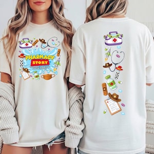 May include: A cream-colored t-shirt featuring a graphic print of pharmacy-themed items including a stethoscope, medical bag, prescription pad, and pills. The front displays the text PHARMACY STORY TO INFINITY AND BEYOND FOR OUR PATIENTS.
