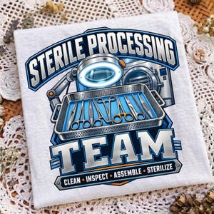 Op de afbeelding: Een wit t-shirt met een afbeelding van een metalen dienblad gevuld met chirurgische instrumenten, een vergrootglaslamp en een autoclaaf. De tekst luidt STERILE PROCESSING TEAM met de woorden CLEAN, INSPECT, ASSEMBLE, STERILIZE in blauw en zilver.