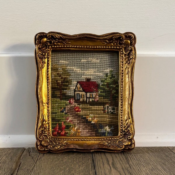 Vintage small house cottage needlepoint in gold baroque frame, under glass