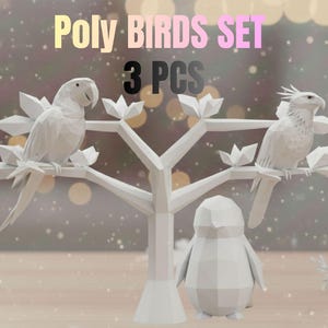 May include: A set of three white geometric bird sculptures. Two birds perch on a stylized tree with geometric leaves, and a penguin stands below. The text "Poly BIRDS SET 3 PCS" is at the top.