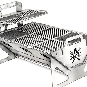 May include: A portable stainless steel charcoal grill featuring a two-tier cooking surface with a raised rack. The side panel displays a graphic of a flame and two crossed grilling tools above the text "GRILL & CHILL" in a black font.