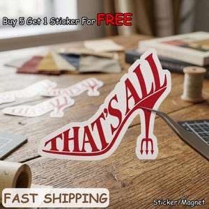 May include: A red and white sticker in the shape of a high-heeled shoe with the words "THAT'S ALL" in a bold font. The sticker has a devil's tail design on the heel. The image also includes the text "Buy 5 Get 1 Sticker For FREE" and "FAST SHIPPING".
