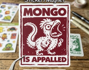 May include: A sticker or magnet with a maroon background and white illustration of a cartoon creature with an open mouth. The text "MONGO IS APPALLED" is above the creature. The words "Sticker/Magnet" are at the top.