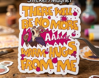 May include: A sticker or magnet with the text "THERE WILL BE NO MORE WARM HUGS FROM ME" in orange and white. The design includes a cartoon goat holding a bottle, with the word "AAAAA!!" in a speech bubble. The sticker is on a wooden surface.