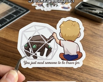 May include: A sticker or magnet featuring a cartoon illustration of a person reaching for a geometric shape containing a brown creature. The text reads "You just need someone to be brave for". The sticker is labeled "Sticker/Magnet".