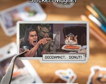 May include: A rectangular sticker/magnet featuring a meme-inspired illustration. The image depicts a person in a Batman-like costume yelling and pointing at a cat wearing a crown, with the text "GODDAMNIT, DONUT!" below.