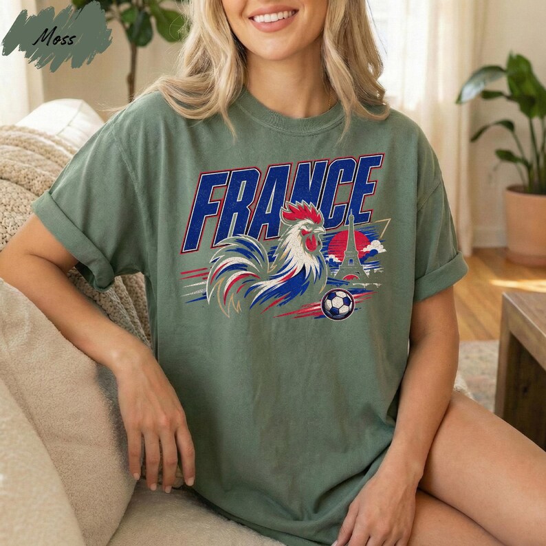A woman wearing a green t-shirt with a graphic of a rooster and the word "FRANCE" printed on it.
