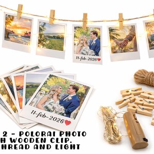 May include: A photo display set featuring several printed photos, wooden clips, jute thread, and string lights. The photos are of various landscape scenes and a couple. The text "11-feb-2026" is visible on some photos. The set includes a battery-powered light.