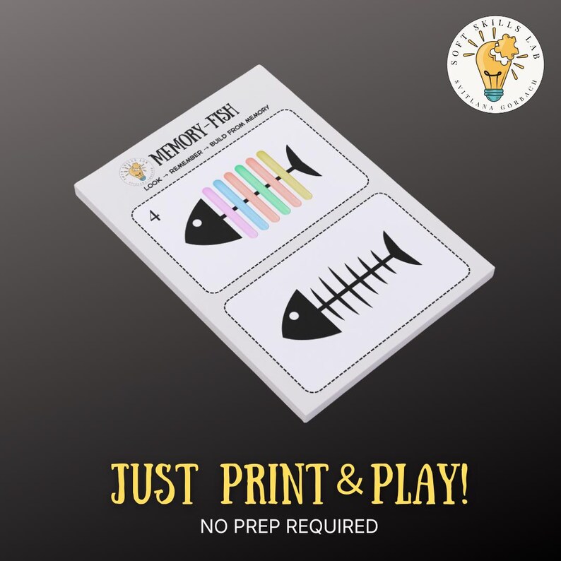 May include: A white card with two fish illustrations, one with colorful bars and the other a black fish skeleton. The text "MEMORY-FISH" and "JUST PRINT & PLAY!" are visible. The card is designed for memory building.
