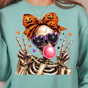 halloween skeleton bubble gum design with purple glasses and orange bow