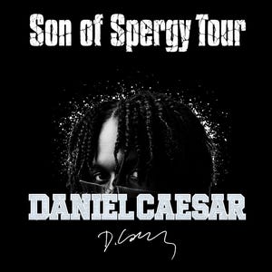 May include: A black graphic print featuring the text Son of Spergy Tour in a distressed white font at the top. Below, a portrait of a person with braided hair, followed by the name DANIEL CAESAR in block letters and a handwritten signature below.