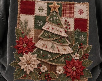 May include: A charcoal grey crewneck sweatshirt featuring a large square patch with a patchwork background of red, green, and cream squares. The design includes a central Christmas tree, red and white poinsettia flowers, and holly berries.