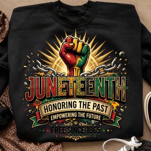 May include: Black sweatshirt with a colorful Juneteenth graphic. The design features a raised fist in red, yellow, and green, with the words "Juneteenth" and "Honoring the Past, Empowering the Future, Free Since 1865."