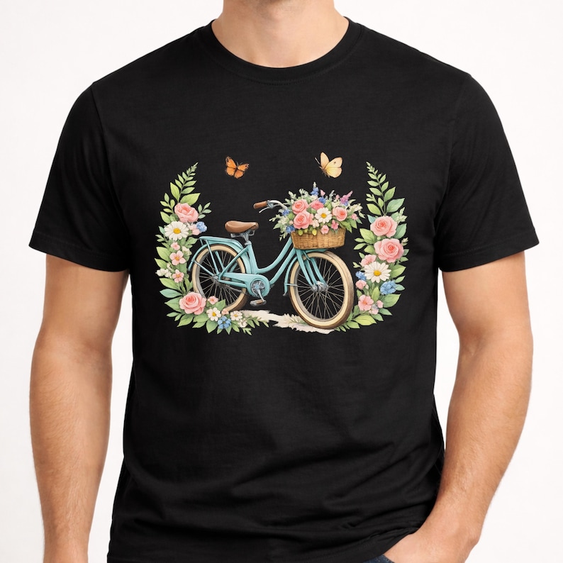 May include: Black t-shirt with a light blue bicycle design, complete with a basket of flowers. The bicycle is set within a floral wreath of pink and white roses, green leaves, and butterflies. A delightful image.