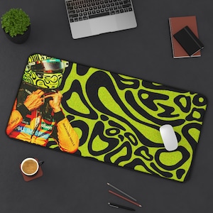 May include: A rectangular mouse mat with a racing driver image and a black and neon green abstract design. A white mouse, a laptop, and a cup of coffee are also visible on the dark surface.