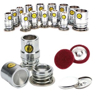 May include: A collection of silver metal button-making tools and components. The image shows various sizes of cylindrical dies with numbers, along with red felt and metal button backs. The tools are for crafting buttons.