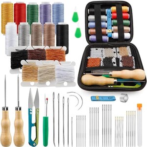 May include: A sewing kit with various colored spools of thread, needles, scissors, and other tools. The kit includes a black zippered case, multiple needles, and a measuring tape. The spools of thread are in various colors, including red, yellow, and blue.