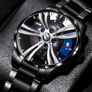 May include: A set of three ceramic mugs with a speckled, matte finish. The mugs are in shades of cream, light gray, and dark gray. Each mug has a simple, minimalist design and a rounded handle.