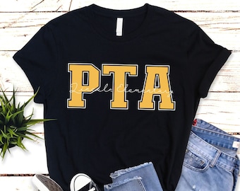 May include: Black t-shirt with a yellow "PTA" graphic in a varsity style font. The text "Elementary" is written in cursive below the letters.