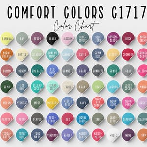 May include: A color chart titled "COMFORT COLORS C1717 Color Chart" displays a variety of colors. Each color is presented on a round sticker with the color name in white text. Colors include Banana, Black, Blue Jean, and Crimson.