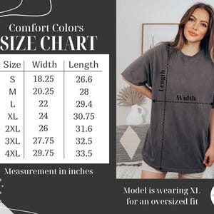 May include: A size chart for Comfort Colors t-shirts, with measurements in inches. The chart includes sizes S to 4XL, with corresponding width and length measurements. A model is wearing an XL shirt for an oversized fit.