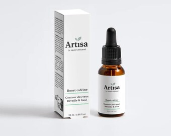 May include: A skincare product set against a white backdrop. The set includes a white box and a brown glass bottle with a black dropper. The box and bottle both feature the "Artisa" logo and text: "Boost caféine, Contour des yeux, Réveille & lisse."