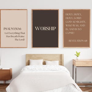 May include: Three framed wall art prints with inspirational quotes. The first print is beige with the text "PSALM 150:6 Let Everything That Has Breath Praise The Lord!". The second print is dark brown with the word "WORSHIP". The third print is brown with the text "HOLY, HOLY, HOLY, LORD GOD ALMIGHTY, WHO WAS, AND IS, AND IS TO COME! REVELATION 4:8".