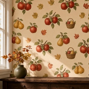 May include: Wallpaper featuring a repeating pattern of red apples, yellow pears, and brown autumn leaves on a cream background. Some apples and pears are arranged in woven baskets. A dark green vase sits on a wooden surface in the foreground.
