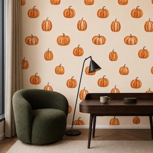 May include: Wallpaper featuring a repeating pattern of orange pumpkins on a light beige background. The pumpkins are illustrated in a simple style with vertical ridges and stems, arranged in a grid-like layout across the entire wall surface.