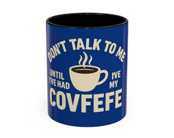 May include: A blue and black coffee mug with the text "DON'T TALK TO ME UNTIL I'VE HAD MY COVFEFE" in white. The mug features a coffee cup graphic with steam rising from it.