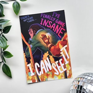 May include: A rectangular art print with the text "I'VE FINALLY GONE INSANE" and "I CAN SEE IT". The artwork features a person with their head in their hands, with a glowing hand and arm. The color palette includes black, green, red, and orange.