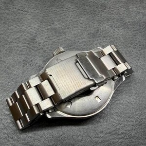 May include: A stainless steel wristwatch featuring a brushed metal link bracelet with a fold-over clasp. The watch case back is circular and metallic, showing a winding crown on the side. The design is utilitarian with a polished silver finish.