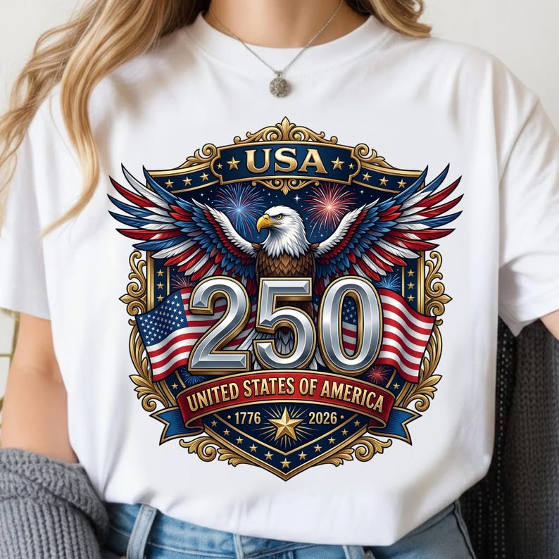May include: White t-shirt featuring a patriotic design celebrating the 250th anniversary of the United States. The graphic includes an eagle, American flags, fireworks, and the text "USA", "250", and "United States of America 1776-2026".