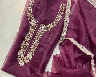May include: A deep plum-coloured sheer fabric garment featuring intricate gold-toned embroidery along the neckline. The piece includes a matching sheer scarf or dupatta with a scalloped gold-toned lace border that runs along the edges.