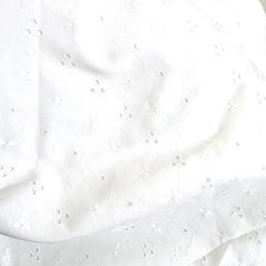 May include: A white fabric featuring an intricate eyelet embroidery pattern. The material displays small, circular cutouts arranged in delicate floral motifs, connected by thin, embroidered stems that create a repeating, light, and airy design.