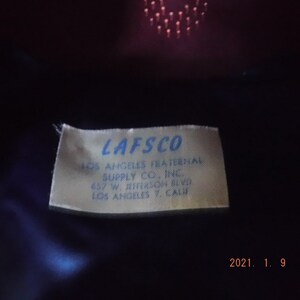 May include: A white label with blue text that reads "LAFSCO Los Angeles Fraternal Supply Co., Inc. 657 W. Jefferson Blvd. Los Angeles 7, Calif."
